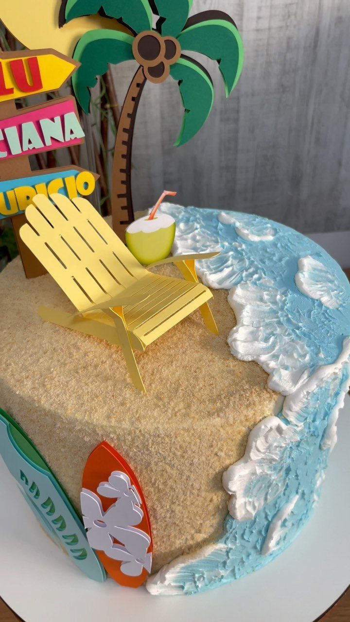 26 Beach Cake Ideas with Blue Ocean Frosting to Sailboats 14 Beach themed cake with sand frosting, blue waves, a yellow chair and palm tree.