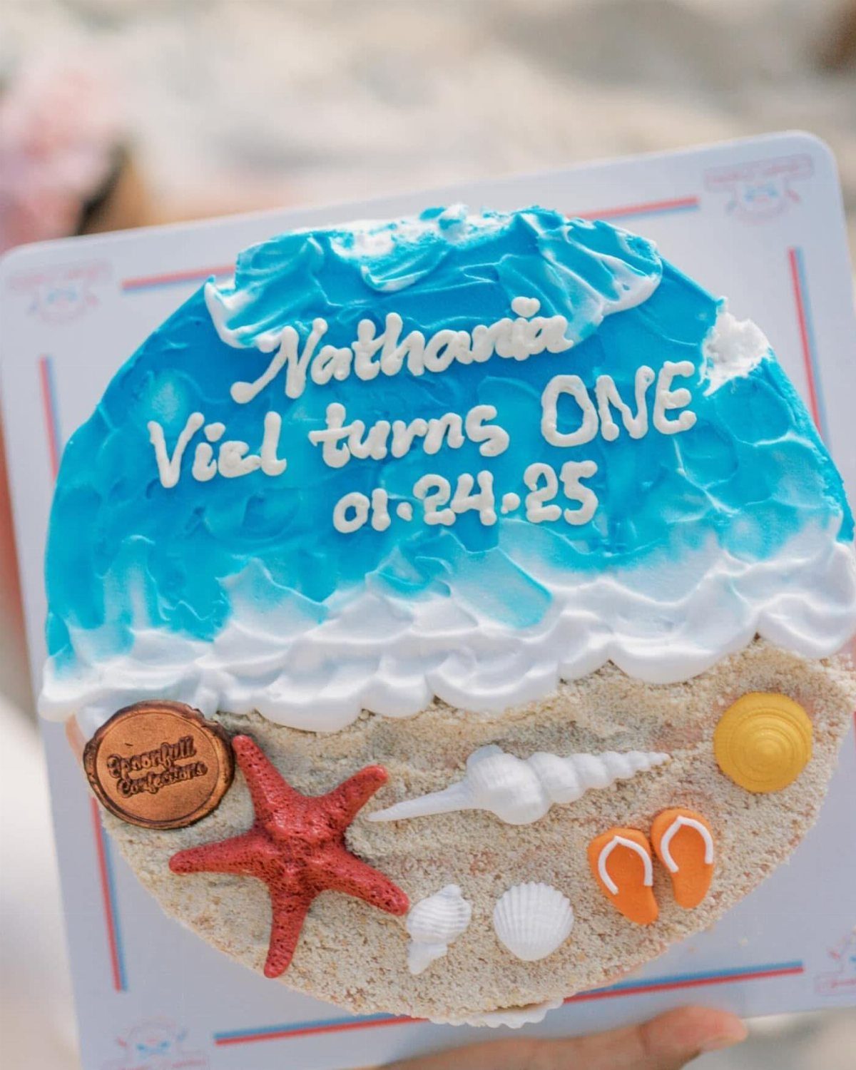 26 Beach Cake Ideas with Blue Ocean Frosting to Sailboats 11 Beach themed cake with blue frosting waves, sandy crumbs, and edible seashells