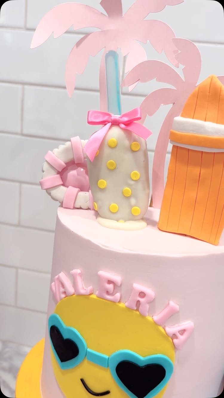 26 Beach Cake Ideas with Blue Ocean Frosting to Sailboats 18 Pink beach themed cake with a smiley face, palm tree, and beach umbrella.
