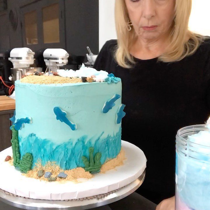 26 Beach Cake Ideas with Blue Ocean Frosting to Sailboats 12 Blue ocean cake with frosting seaweed, blue fish, and sandy cake crumbs.