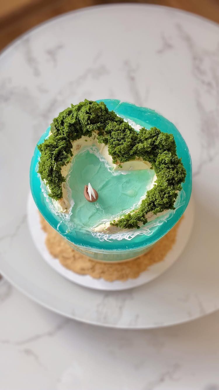 26 Beach Cake Ideas with Blue Ocean Frosting to Sailboats 6 Cake with a translucent blue gelatin ocean top and green mossy edges.