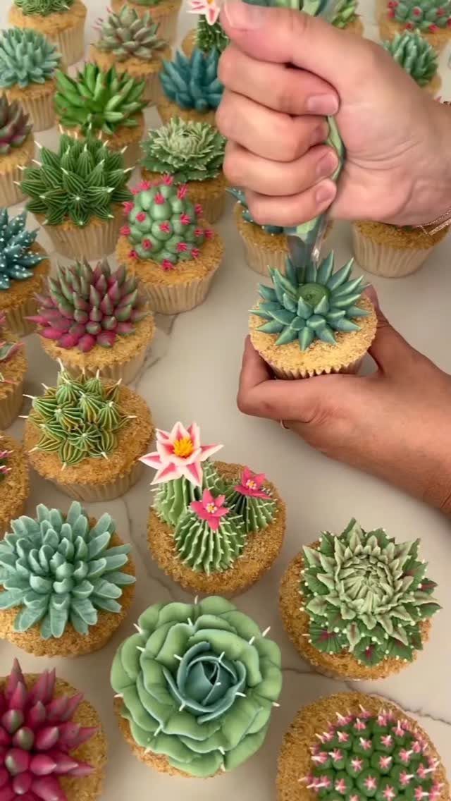12 Cupcake Cake Ideas for Your Next Celebration 8 Cactus cupcakes with green and pink frosting and small edible flowers.