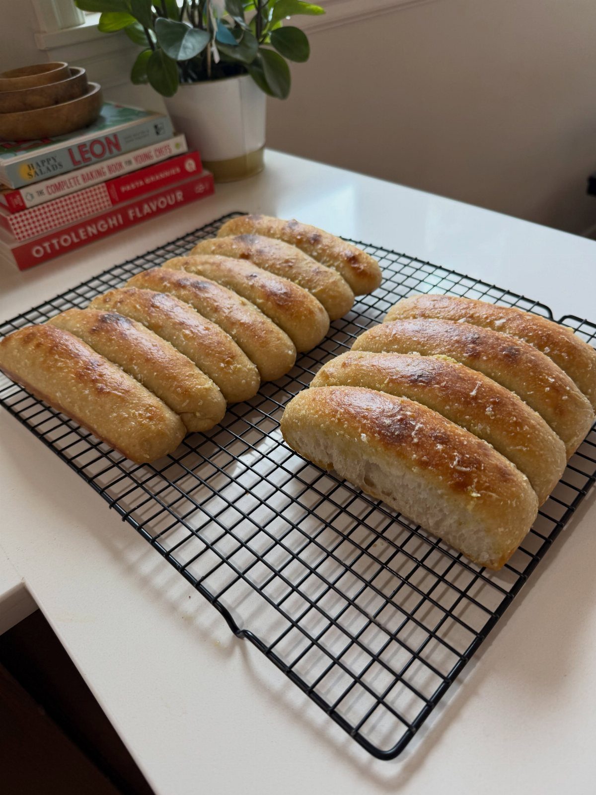 Sourdough Discard Breadsticks with 9 Flavor Ideas 2 Golden brown breadsticks cooling on a black wire rack on a white counter.
