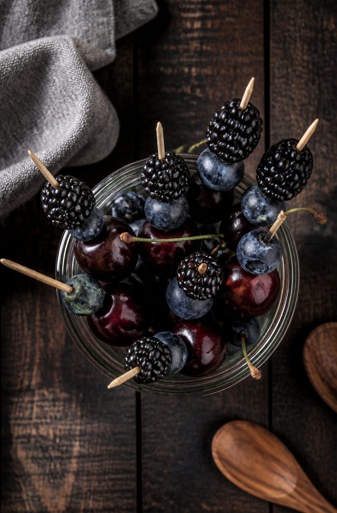 16 Wednesday Snack Ideas for 2026: Dark, Sweet and Savory 2 Skewers of blackberries, blueberries, and dark cherries on a plate.
